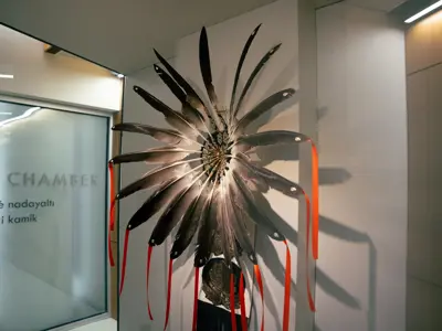 A feather piece with very intricate beading displayed in Jubilee lobby