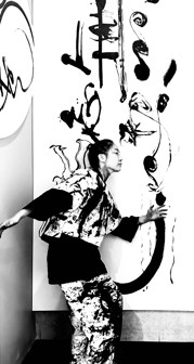 Cui posing in front of her work