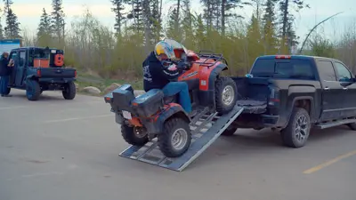 Photo of a person unloading their quad at an OHV staging area 