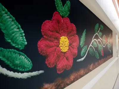 Intricate details of a mukluk, spread into a wide frame displayed in Jubilee lobby